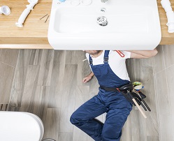 sanitary-technician-lying-sink